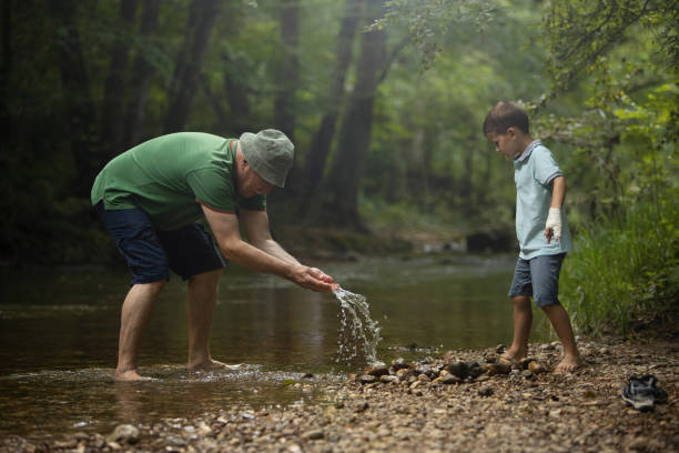 istock Grandson and grandfather at river 1296460339
