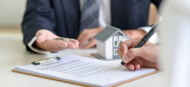 istock Signing a loan for a home purchase. 1296463809