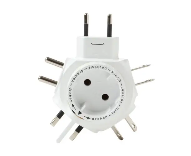 Travel plug adapter isolated on white background with text „turn“ in seven languages