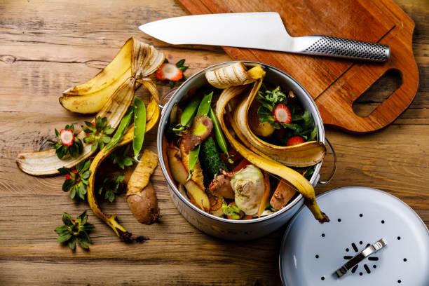 istock Compost Bucket and Bio waste trash Cooking process on wooden background 1296464938