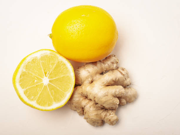 istock Top view of ginger and lemon on a light beige background close up 1296465879