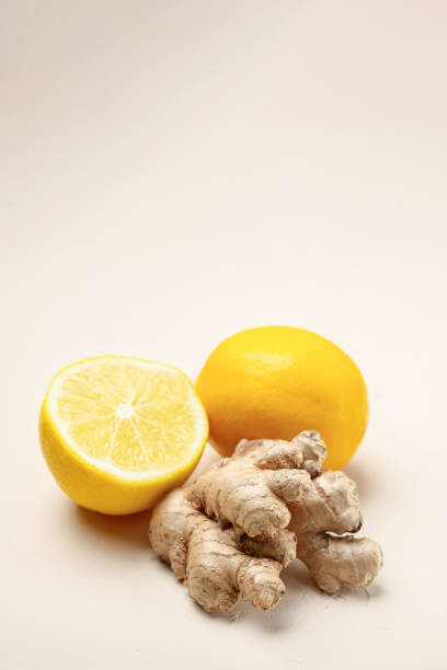 istock Close-up of ginger and lemon on a light beige background with copy space 1296465961