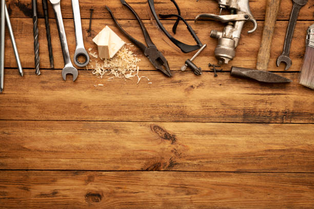 istock Messy workshop hand tools piled on a wooden desk 1296467030