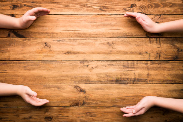 wooden table background with hands gesturing