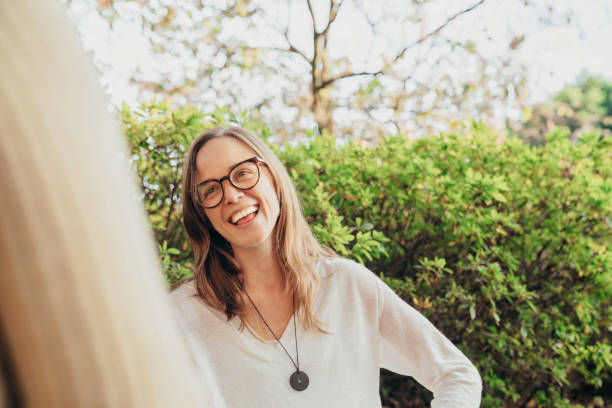 istock Woman smiling while talking to a friend 1296468228