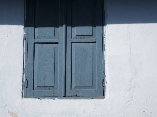 istock Wooden windows with white walls 1296468647