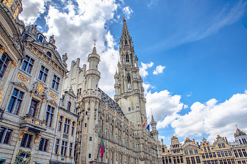 Brussels, Belgium - July 20, 2020: Tower of the city hall at the Grand place central square in the old town of Brussels