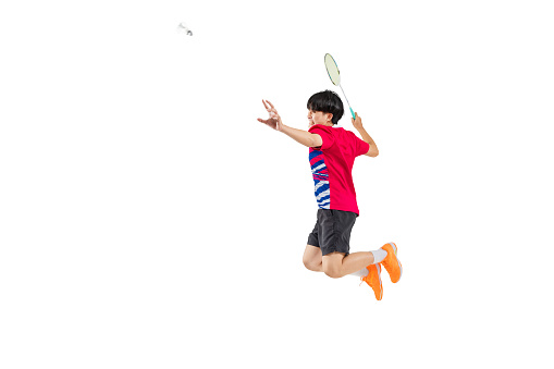 Asian badminton player is hitting in white background