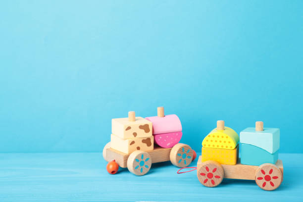 istock Stacking train toddler toy for little children on blue background with shadow reflection. 1296473566