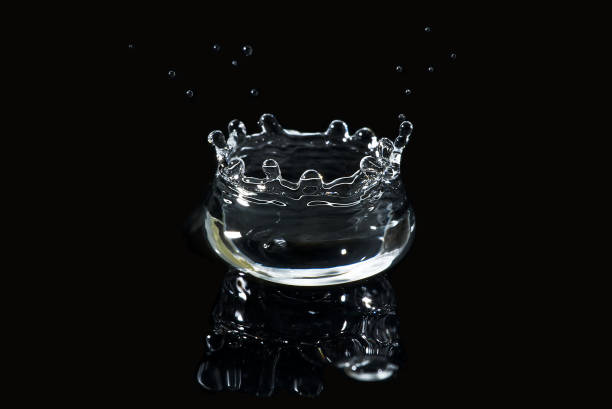 istock water splash isolated on black. fresh clean transparent drinking water splash. 1296473699