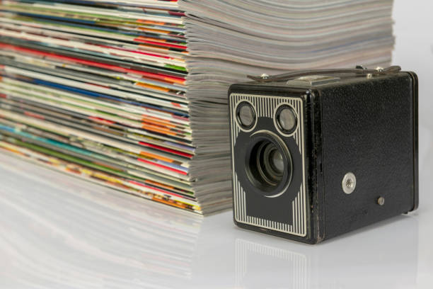 istock Antique cameras and magazines against a white background. 1296473712