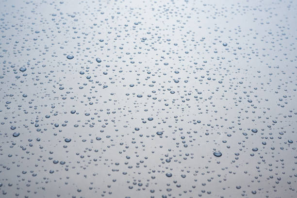 istock Small drops of water on a gray background. 1296474437