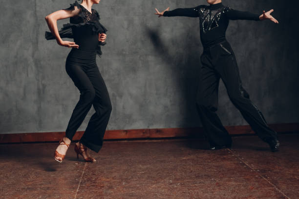 istock Young couple dancing in ballroom dance cha-cha-cha. 1296474930
