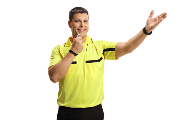 istock Smiling football referee blowing a whistle and pointing 1296475906