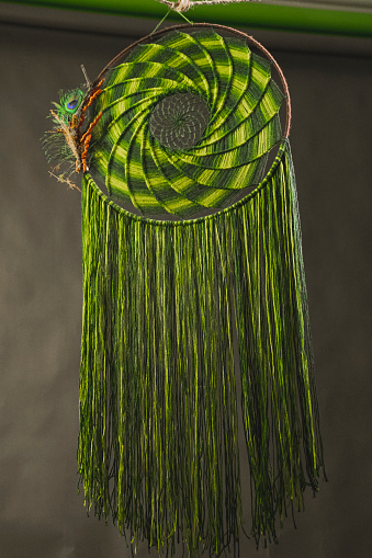 dream catcher made with green thread and beads