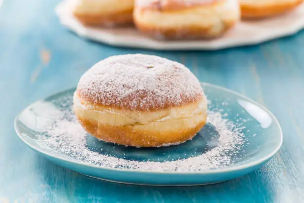 Traditional German Krapfen, Berliner or donuts with icing sugar