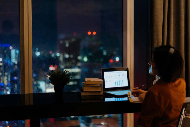 istock Young woman working late at home 1296479584