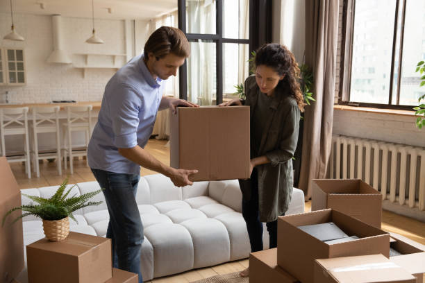 Young couple packing relocating to new house