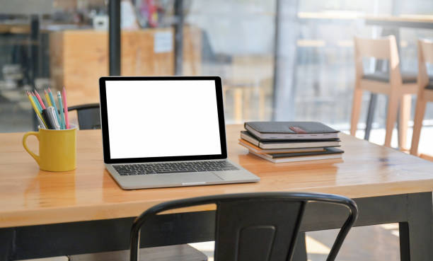 istock A laptop and notebook with stationery are placed on the table in the comfortable workspace. 1296480402
