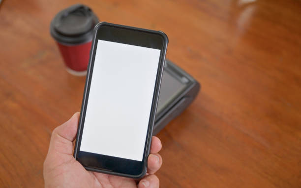 istock Customers use a smartphone scan to pay from the payment terminal. 1296480425