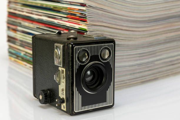 istock Antique cameras and magazines against a white background. 1296481473
