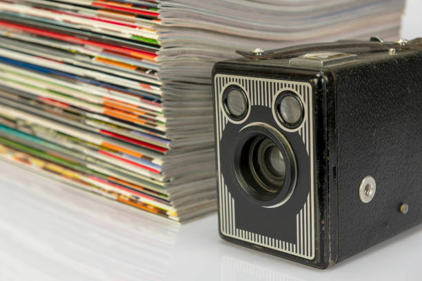 istock Antique cameras and magazines against a white background. 1296481654
