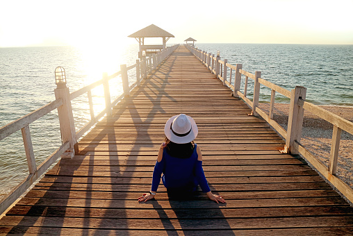 Young Woman in White Hat Sitting on the Wooden Pier, Chon Buri City, Thailand, ( Self Portrait )