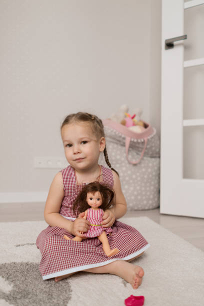 istock Little girl playing with a doll 1296486625