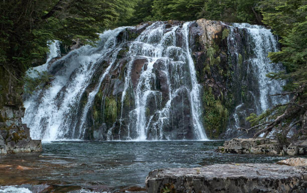 istock waterfall hidden among forests nestled between high and remote mountains 1296487240