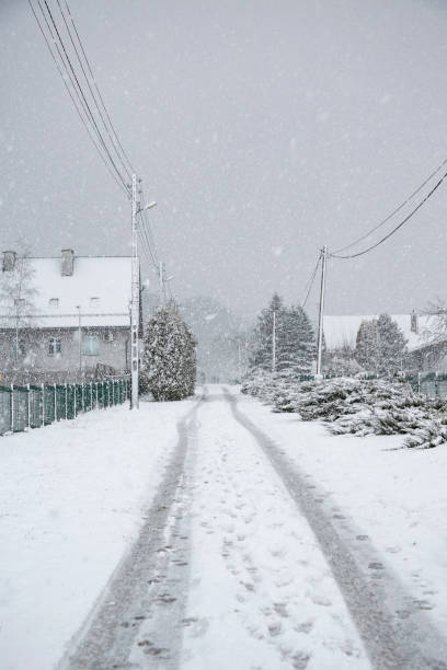 istock rural street during snowstorm 1296487310