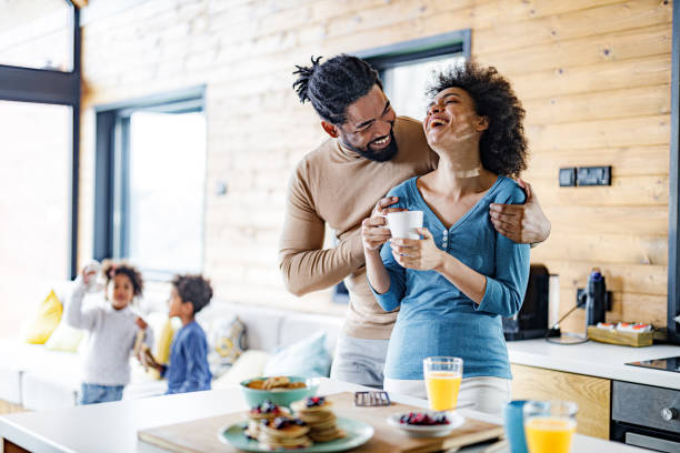 istock Cheerful black parents having fun during morning time at home. 1296489048
