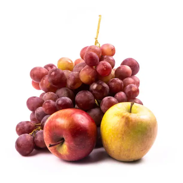 Photo of Bunch of grapes and apples on white background