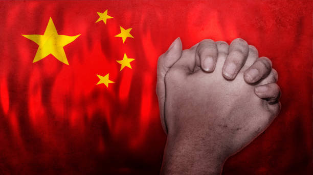 istock A hand praying with Flag of China as background. 1296489688