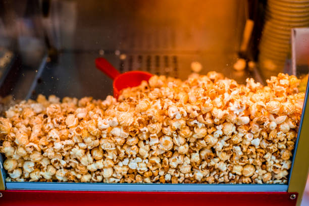 istock Sweet popcorn shop close up view 1296489860