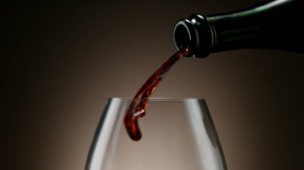 istock Pouring red wine into wine glass 1296492435