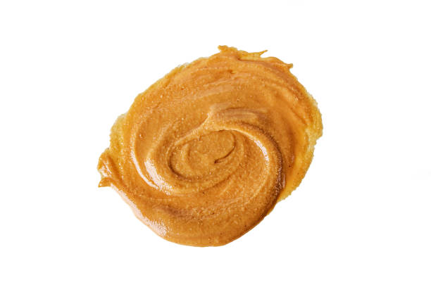 istock Homemade Creamy peanut butter or paste isolated on white background. 1296492745