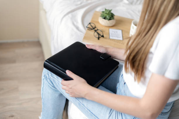 istock Blonde woman in bed with book 1296493167