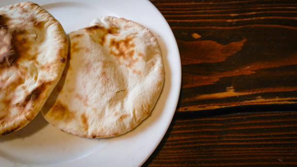 istock Two small bread tortillas stand in a plate on the table 1296494035