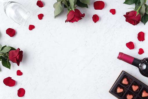 Top view of Valentine day chocolate with rose and wine, festive gift design concept for special holiday dating.