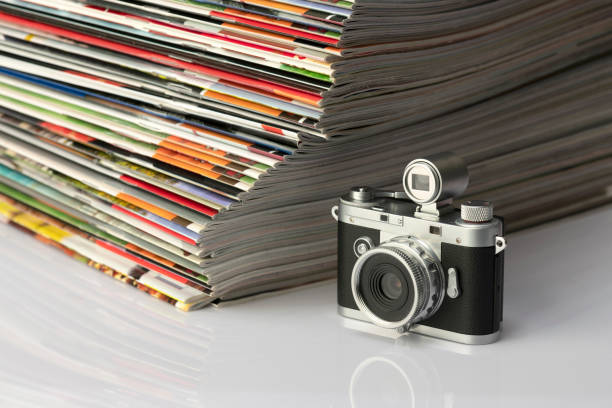 Antique cameras and magazines against a white background.