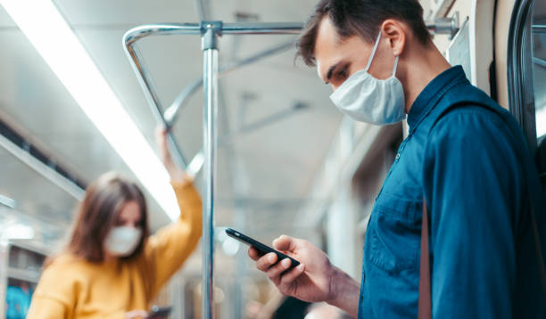 istock young woman in a protective mask standing in a subway car 1296497825