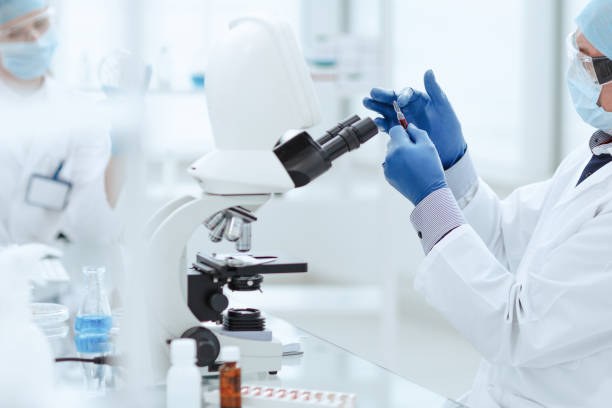 istock scientist opening an ampoule with a new vaccine 1296498130
