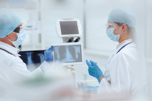 istock close up. medical colleagues discussing the x-ray 1296498209