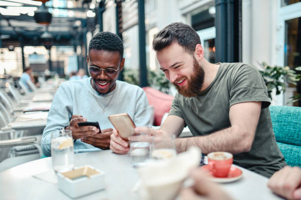istock Multi Racial Friends Exchanging Phone Contact Info 1296498900
