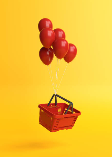 Flying shopping basket with balloons on a yellow background