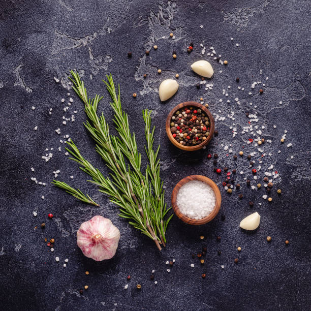 istock Herbs and condiments on black stone background 1296502443