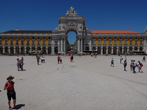 Lisbon, Lisbon, Portugal- June 2, 2019: Tourists wandering the large public square Praca do Comercio. Lisbon, Portugal.
