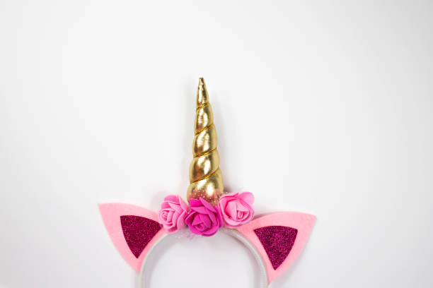 istock Unicorn horn on a rim with flowers on a white background. 1296504677