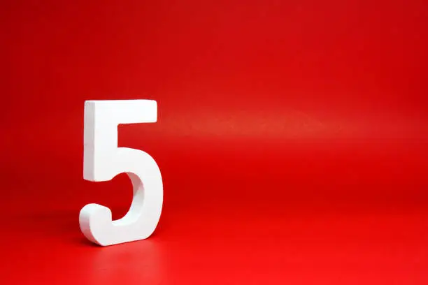 Five ( 5 ) white wooden  Isolated Red Background with Copy Space - New promotion 5% Percentage  Business finance Concept