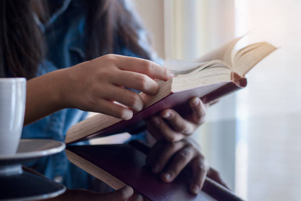 istock woman reading book at home 1296506298